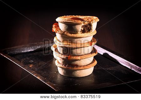 Meat Pies with sauce and high contrast lighting.