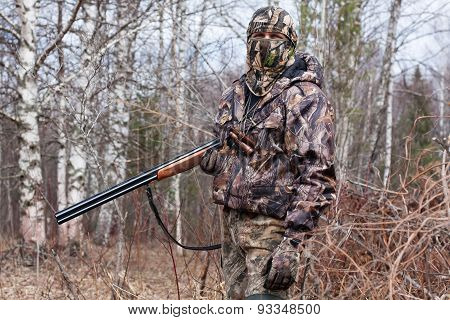 Hunter In The Camouflage With Gun