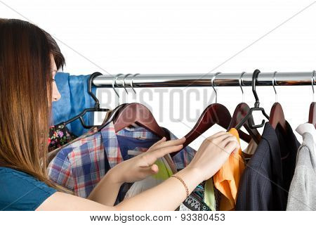 Beautiful Young Woman Near Rack With Clothes
