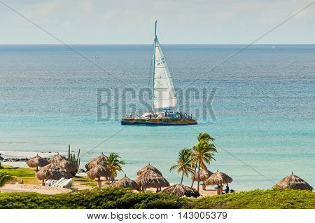 Oranjestad Aruba - December 01 2011: Tourists on a catamaran Palm Pleasure enjoy the beautiful tropical island of Aruba at December 01 2011.