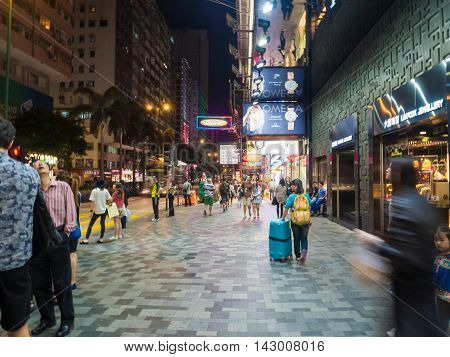 HONG KONG CHINA - OCT 22: Crowded street view at night on October 22 2015 in Hong Kong China. With 7M population and land mass of 1104 sq km it is one of the most dense areas in the world.
