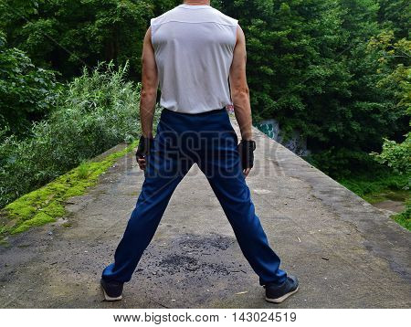 Rear view of a man in a vest and pants