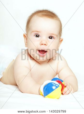 Happy child playing with ratte - baby 5 months old