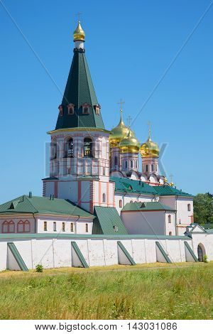 The bell tower Iversky Svyatoozersky Mother of God Monastery closeup july sunny day. Valday Russia