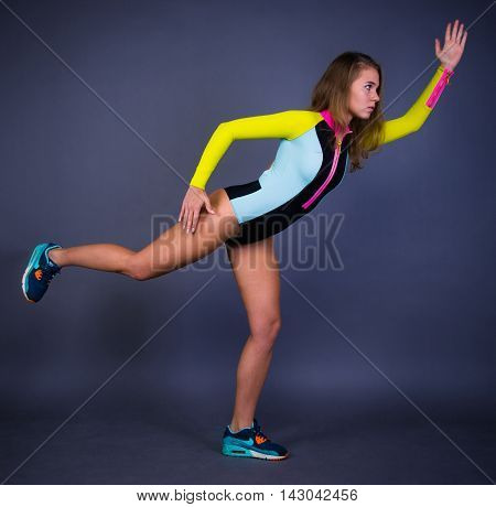 Active sport girl posing on black background
