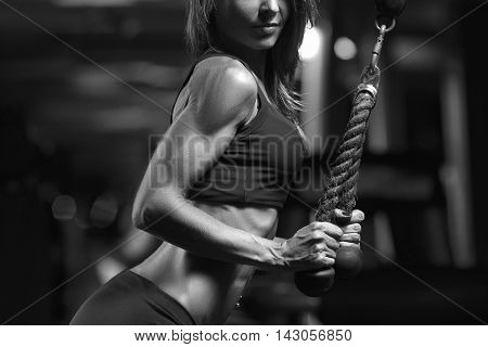 Black and white photo fitness woman in the gym. Young woman doing fitness exercises in the gym.