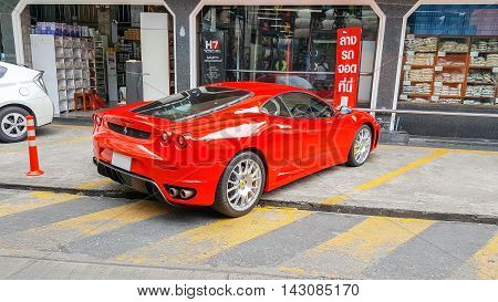 Bangkok,Thailand-Aug 5,2016:Beautiful  luxury sports car Ferrari F430 on the street park in front of a supermarket.
