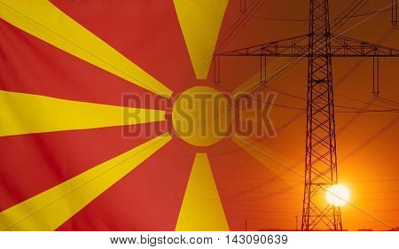 Concept Energy Distribution Flag of Macedonia with high voltage power pole during sunset