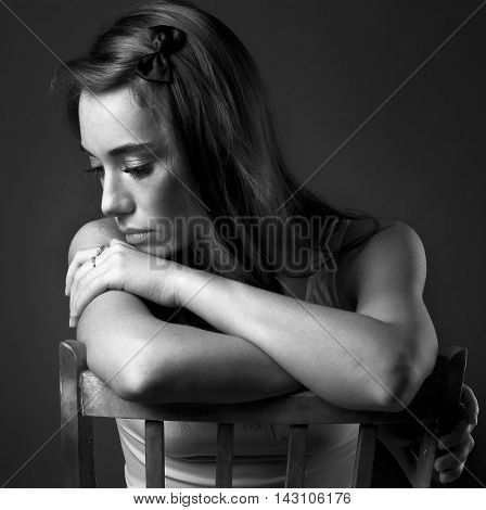 beautiful girl with a melancholy on dark background