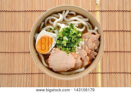 Japanese noodles Udon with chicken and boiled egg in soybean paste (Miso) soup on a mat
