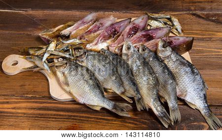 Dried fish on a wooden table composition