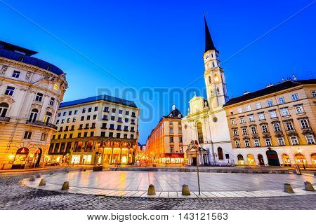 Vienna Austria. Michaelerplatz wide-angle view at dusk with Michaelkirche Habsburg Empire landmark in Wien
