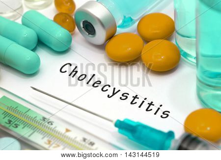 Cholecystitis - diagnosis written on a white piece of paper. Syringe and vaccine with drugs.