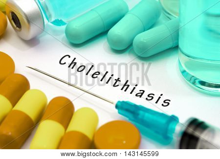 Cholelithiasis - diagnosis written on a white piece of paper. Syringe and vaccine with drugs.