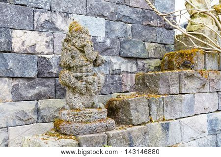 Statue of ganesha hindu god and ancient temple wall, asian induism background