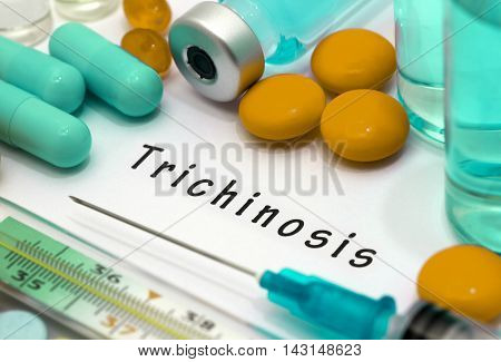 Trichinosis - diagnosis written on a white piece of paper. Syringe and vaccine with drugs