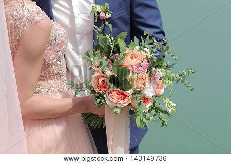 Beautiful Bridal Bouquet In Hands Of The Bride. Wedding Bouquet Of Peach Roses By David Austin,  Sin