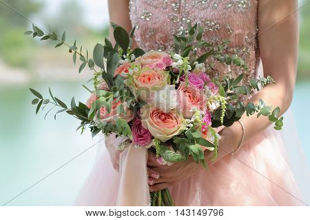 Beautiful Bridal Bouquet In Hands Of The Bride. Wedding Bouquet Of Peach Roses By David Austin,  Sin