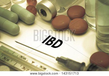 IBD (inflammatory bowel disease). Treatment and prevention of disease. Syringe and vaccine. Medical concept. Selective focus
