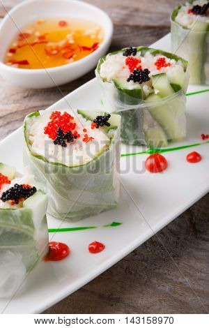 Spring roll with caviar cucumber and cili sauce