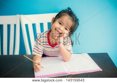 asian young girl children happy doing her homework people, family concept