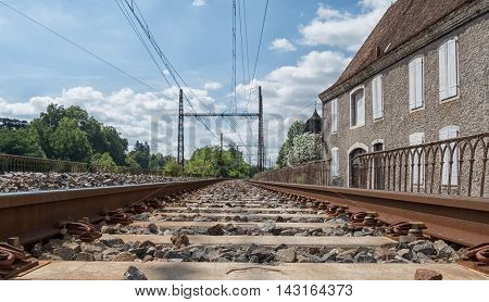 Railway track with Orthez village in France