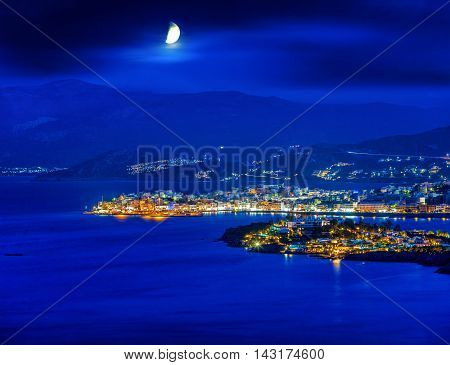 Agios Nikolaos at night Crete Greece. Agios Nikolaos is a picturesque town in the eastern part of the island Crete built on the northwest side of the peaceful bay of Mirabello.