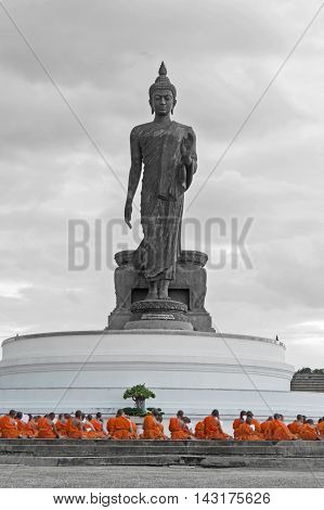 Nakhon Pathom, Thailand - August 4, 2016: Buddhist Monks Praying In Front Of Walking Buddha Statue A