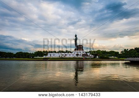 Sunset Over Walking Buddha Statue At Buddhamonthon (phutthamonthon), Buddhist Park In Nakhon Pathom,