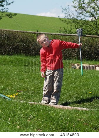 Little boy after playing golf on vacation