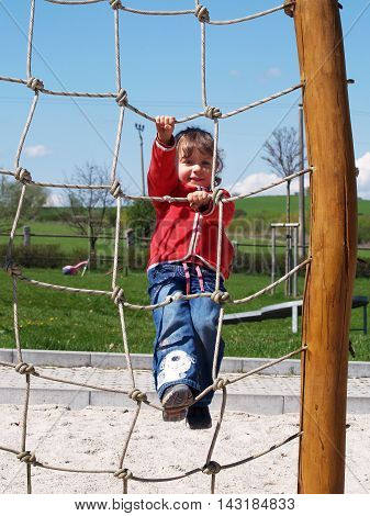 Little girl climb up on the playground