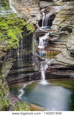Rainbow Falls flows down a rocky gorge wall alongside the Triple Cascade at New York's Watkins Glen State Park.