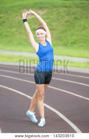 Young Caucasian Female Athlete Training on Sport Venue Outdoors. Vertical Image