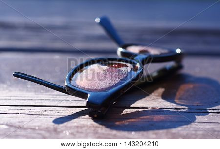 glasses in the morning dew sitting on the wood