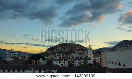 Quito Pichincha / Ecuador - August 16 2016: Sunset on Independence Square in the historic center with Virgen del Panecillo in background. It was declared by UNESCO the first Cultural Heritage on 1978