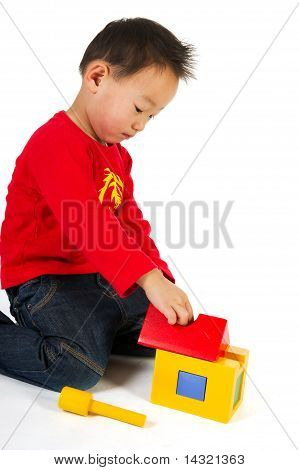 Chinese Boy Playing With Toys