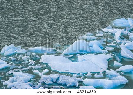Melting blue ice floes in the water in the Argentine Patagonia.