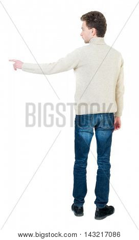 Back view of pointing business man.  Rear view people collection.  backside view of person.  Isolated over white background. Curly short-haired man in a woolen white jacket shows a finger in the side.