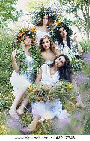 Five beautiful girls in wreaths celebrate Midsummer. Kupala Night