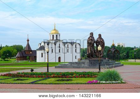 VITEBSK BELARUS - JULY 13 2016: Monument to Prince Alexander Nevsky and his wife Princess Alexandra of Vitebsk and son of Basil Annunciation Church and Church of Holy Prince Alexander Nevsky