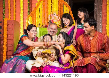 group photo of cheerful indian family in ganesh festival, happy indian family and ganpati festival