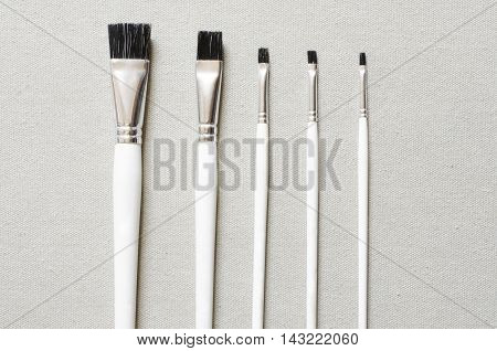 paint brushes artist tool on fabric background