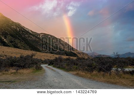 Rainbow over mountain near Lake Pearson / Moana Rua Wildlife Refuge located in Craigieburn Forest Park in Canterbury region South Island of New Zealand