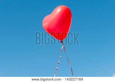 Valentine heart balloon against blue sky background