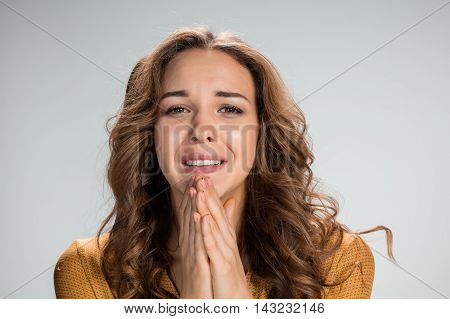 The Woman is looking imploring over gray background