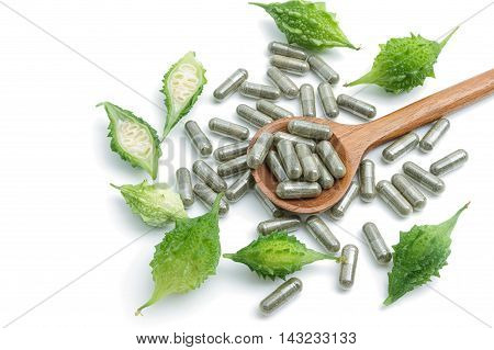 Herb pills with bitter gourd homeopathic medicine on white background