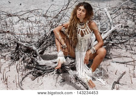 Attractive wild boho woman at beach. Native american style