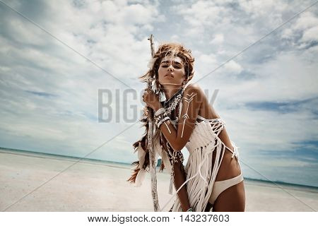 Attractive wild boho woman at beach. Native american style