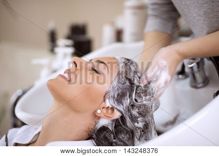 Portrait of women which wash hair in a beauty salon.Hairdresser washing hair.