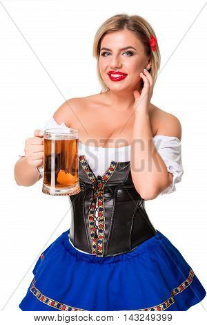 Beautiful young blond girl in dirndl drinks out of oktoberfest beer stein. Isolated on white background.
